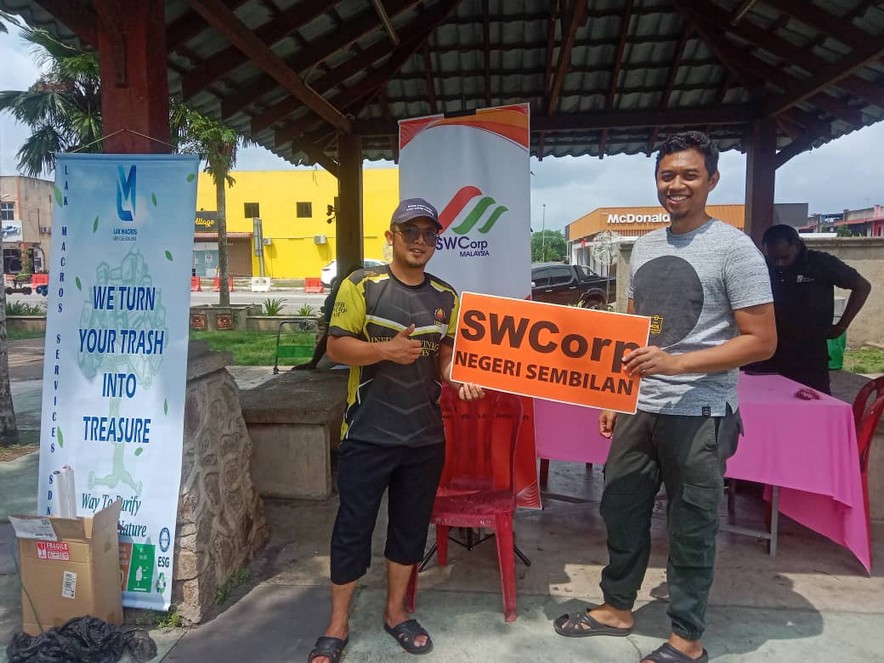 Community members handing over e-waste and recyclables